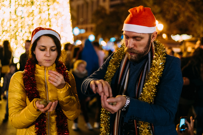 Couple in Spain eating grapes at midnight on New Year's eve