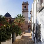 Street with the historic main church of Denia in Spain