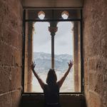 Girl in a window of the castle of Denia in Spanje