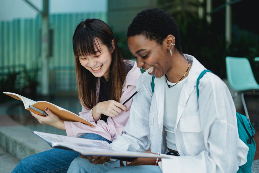 Girls learning Spanish with books