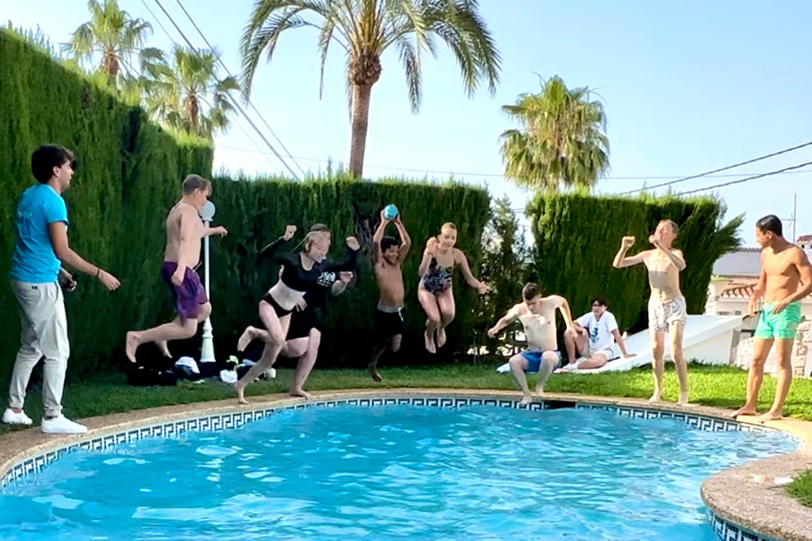 Spanish students from a school group jumping into the pool