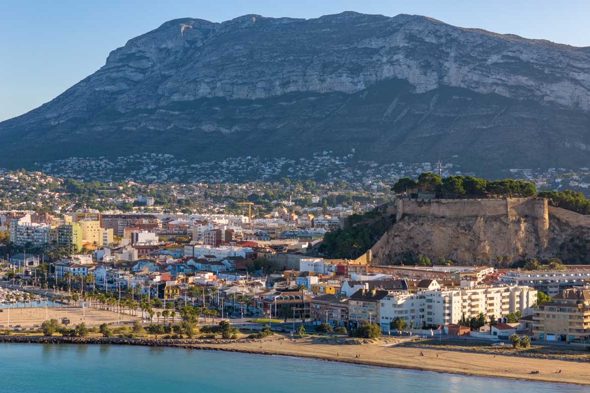 Aerial image of the beach, castle, buildings and mountains in Denia, Spain