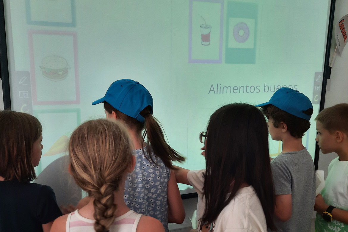 Children playing on the blackboard in a Spanish course activity