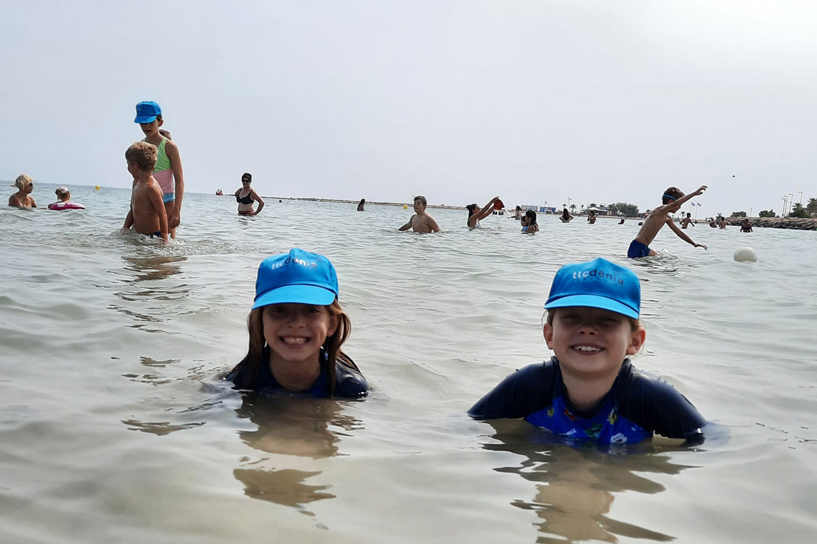 2 children bathing in the sea in Denia, Spain