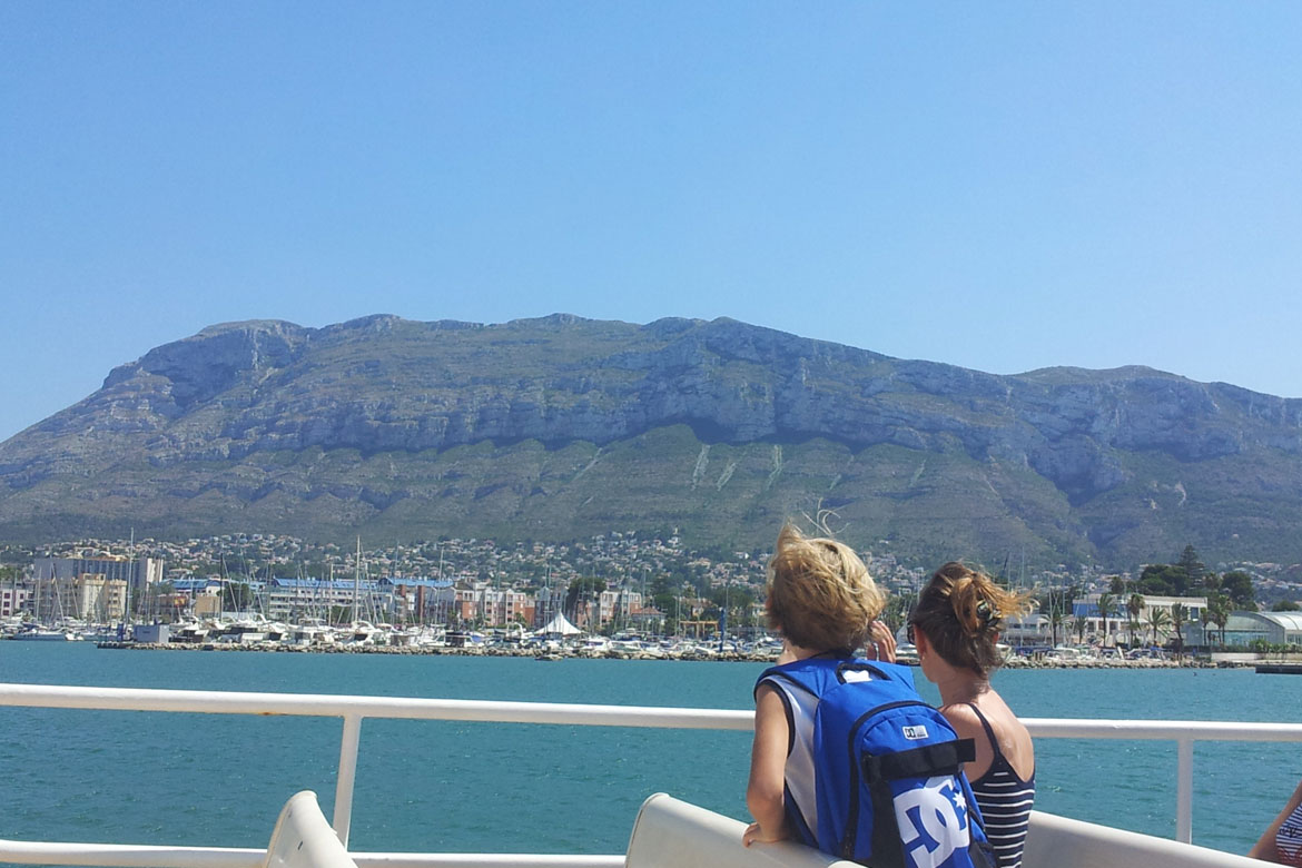 2 people on a boat looking at Denia's mountain