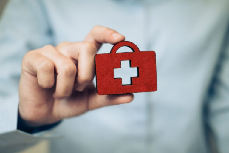Hand holding a symbol of insurance for student visa